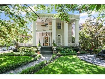 Stately home featuring elegant columns and a beautifully landscaped front yard at 908 N Highland Ne Ave, Atlanta, GA 30306