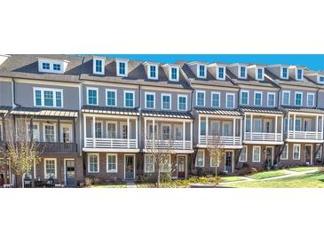 Row of gray townhomes featuring brick accents, white trim, and dormer windows at 1975 Flying Scotsman Dr # 18, Kennesaw, GA 30144