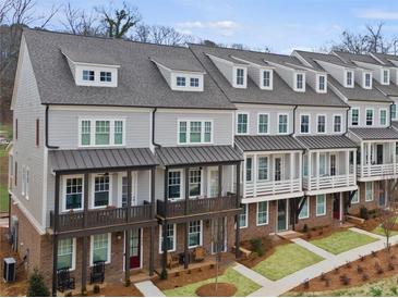 Charming townhome exteriors with neutral siding, covered porches, and well-manicured lawns showcase an inviting community at 1975 Flying Scotsman Dr # 18, Kennesaw, GA 30144