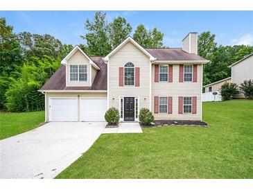 Charming two-story home with a manicured lawn and a two-car garage at 4530 Talon Way, Douglasville, GA 30135