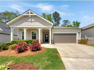 Charming single-Gathering home with a well-manicured lawn, blooming flowerbeds, and a convenient two-car garage at 108 Hickory Run, Canton, GA 30115