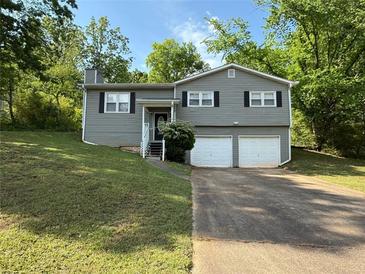 Charming split-level home with a two-car garage and well-maintained front yard at 3990 N Quail Dr, Douglasville, GA 30135