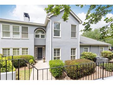 Charming two-story home with a well-manicured lawn and lush landscaping offering a welcoming curb appeal at 3910 Ashford Lake Ne Ct, Brookhaven, GA 30319