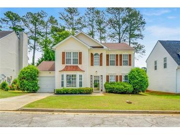 Charming two-story home with landscaped yard, inviting curb appeal, and attached garage at 3550 Willow Tree Trce, Decatur, GA 30034