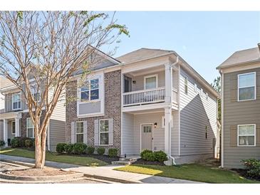 Charming two-story home with gray siding, brick accents, a cozy balcony, and well-maintained landscaping at 875 Venture Sw Way, Atlanta, GA 30331