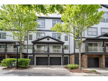 Charming townhome featuring a covered balcony, two-car garage, and manicured landscaping at 220 Semel Cir # 150, Atlanta, GA 30309