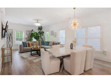 Bright living room with modern decor, hardwood floors, and a stylish dining area with a marble table at 3272 Stillwood Dr, Atlanta, GA 30354