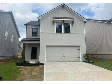 New construction featuring a two-car garage and brick and siding exterior at 4534 Eastbrook Pl, Snellville, GA 30039