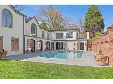 Stunning backyard pool and patio with brick accents create a luxurious outdoor living space at 228 Mount Vernon Dr, Decatur, GA 30030