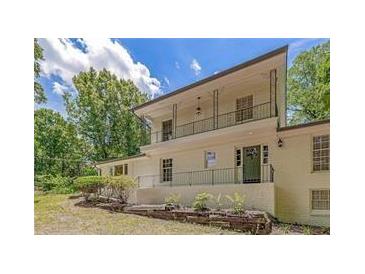 Lovely two-story home boasts an upstairs balcony overlooking the front yard and mature shade trees at 315 Renae, Marietta, GA 30060