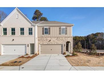 Newly constructed two-story home featuring a painted brick facade and neutral color scheme at 4511 Twinberry Dr, Powder Springs, GA 30127