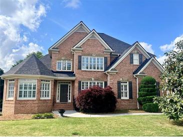 Beautiful brick two-story home with manicured lawn, dark shutters, and well-maintained landscaping at 2922 Heart Pine Way, Buford, GA 30519