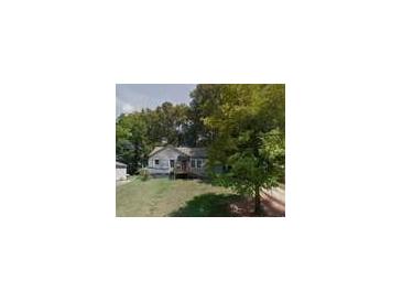 Traditional single-story home with wood siding, front porch, and mature shade trees at 1369 Bluefield Sw Dr, Atlanta, GA 30310