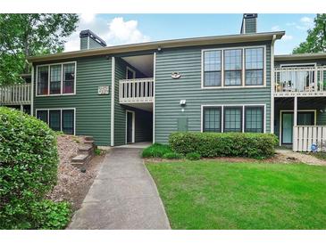 Green multi-Gathering home exterior with lawn, walkway, and multiple entryways at 2638 Vinings Central Se Dr # 4, Atlanta, GA 30339