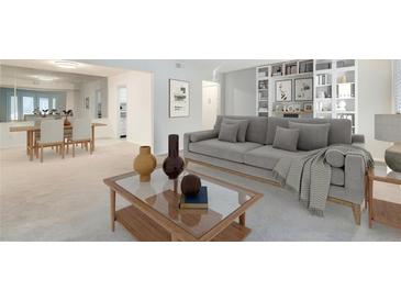 Bright living room featuring a large grey couch, decorative bookshelf, and an adjacent dining area at 6851 Roswell Rd # H1, Sandy Springs, GA 30328