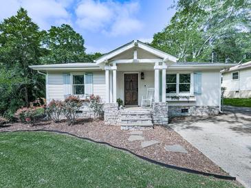 Charming home with stone accents, shutters, a rocking chair, and beautiful landscaping at 2660 Birch Se St, Smyrna, GA 30080