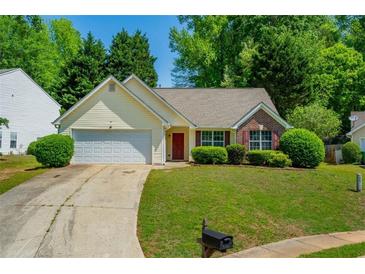 Charming single-story home with manicured lawn, attached garage, and inviting curb appeal at 648 Bellingham Dr, Sugar Hill, GA 30518