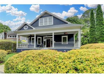 Charming single-Gathering home with a blue exterior, spacious front porch, and manicured landscaping at 799 Monroe Ne Dr, Atlanta, GA 30308
