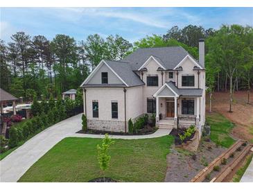 Charming two-story brick home featuring a landscaped yard and a spacious driveway at 1525 Tapestry Rdg, Lawrenceville, GA 30045