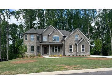 Charming new construction home with stone and siding exterior and a well-manicured front lawn at 4050 Sierra Vista Cirs, Cumming, GA 30040