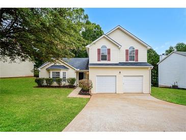 Charming two-story home featuring a well-manicured lawn and a two-car garage at 4438 Tuckahoe Ct, Douglasville, GA 30135