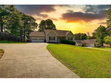 Charming single-Gathering home with a sprawling front yard and a long, curved driveway at 65 Ashland Farm Rd, Oxford, GA 30054