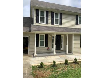 Charming two-story home with a welcoming front porch and classic black shutters at 985 Romer Pl, Stone Mountain, GA 30083