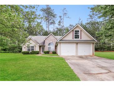 Charming single-Gathering home with a well-maintained lawn and a two-car garage at 155 Oak Terrace Dr, Covington, GA 30016
