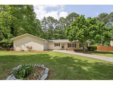 Charming one-story home features a well-manicured lawn and a quaint, inviting facade at 6292 Field Glen Rd, Stone Mountain, GA 30087