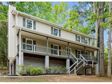 Charming two-story home with a covered front porch and well-maintained landscaping at 1627 Rex Dr, Marietta, GA 30066