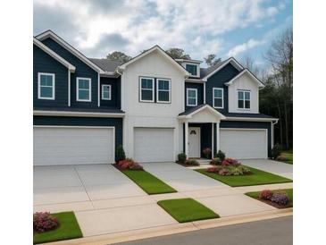 Charming townhomes feature dark and white exteriors with well-manicured landscaping and attached garages at 4011 Redan Rd # 8, Stone Mountain, GA 30083