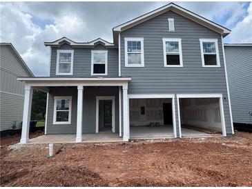 Two-story home with gray siding, white trim, a covered porch, and an attached two-car garage at 1006 Starmoss Lane, Conyers, GA 30094