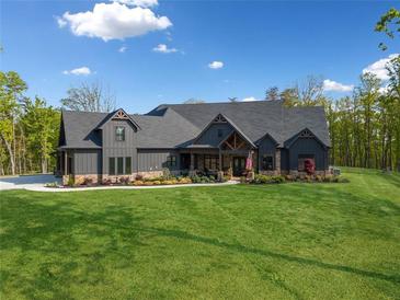 Craftsman-style home features a lush front lawn, stone accents, and a welcoming front porch at 281 Abbott Dr, Canton, GA 30114