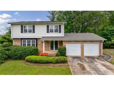 Charming two-story home with brick and vinyl siding, an attached two-car garage, and a well-maintained front yard at 3909 Ebenezer Rd, Marietta, GA 30066