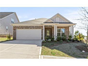 Charming one-story brick home featuring a two-car garage and well-maintained landscaping at 488 Village Ln, Fairburn, GA 30213