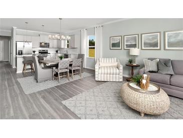 Open-concept living room with modern decor, includes kitchen, dining area, and living space at 488 Village Ln, Fairburn, GA 30213