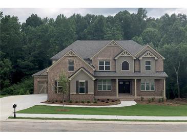 Beautiful brick two-story home featuring a landscaped front yard and attached two-car garage at 4015 Sierra Vista Cir, Cumming, GA 30040