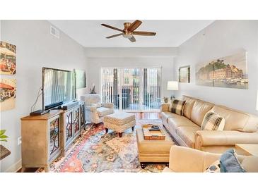 Inviting living room featuring hardwood floors and sliding glass doors to a balcony at 200 River Vista Dr # 436, Atlanta, GA 30339