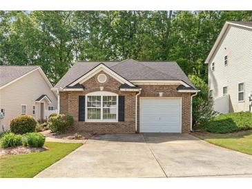 Charming brick home featuring a one-car garage and meticulously maintained landscaping in a desirable community at 171 Nacoochee Way, Canton, GA 30114