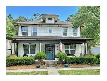 Charming two-story home with a covered front porch and landscaped front yard, perfect for relaxing outdoors at 178 Mission Oak Dr, Grayson, GA 30017
