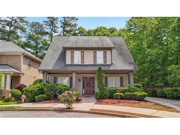 Charming two-story home features a well-manicured lawn and inviting front porch at 3800 Market Walk, Clarkston, GA 30021