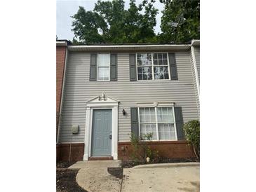 Charming two-story home with gray siding and a decorative doorframe at 5574 Fair Creek Way, Lithonia, GA 30038