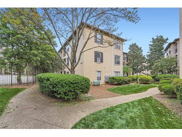 A beautiful apartment building featuring lush landscaping and charming architectural details at 3777 Peachtree Ne Rd # 1512, Brookhaven, GA 30319