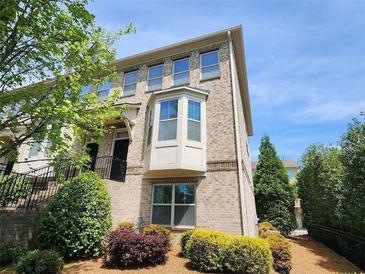 Beautiful two-story townhouse with brick exterior and manicured landscaping at 10650 Allon Cv # 137, Alpharetta, GA 30022