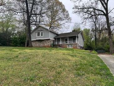 Charming home features a stone foundation and a welcoming covered front porch at 4447 Lake Breeze Dr, Stone Mountain, GA 30083