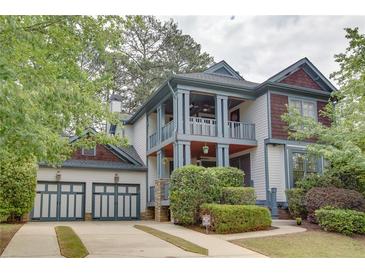 Charming two-story home with a two-car garage, inviting porch, and mature landscaping at 2604 Porchside Se Pl, Atlanta, GA 30316