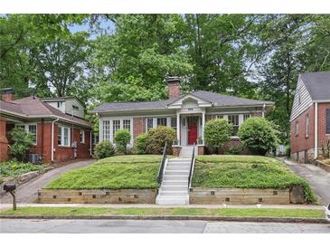 Charming brick bungalow with lush front lawn and inviting red door entrance at 203 Lucerne St, Decatur, GA 30030
