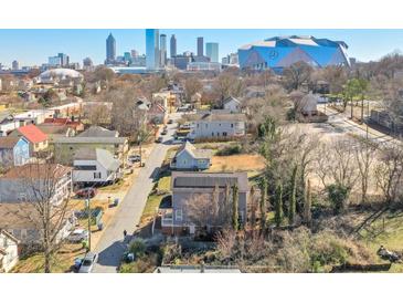 Charming neighborhood street view with Atlanta skyline and Mercedes Benz stadium in the background at 660 Delbridge Nw St, Atlanta, GA 30314