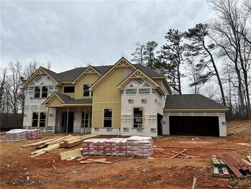 New construction home showing siding, windows, and garage; materials in the yard, and wrap installed at 4085 Sierra Vista Cir, Cumming, GA 30040