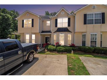 Charming townhome with beautiful curb appeal, manicured lawn, and inviting entrance, close to the neighborhood at 7324 Bridlewood Ct, Jonesboro, GA 30236